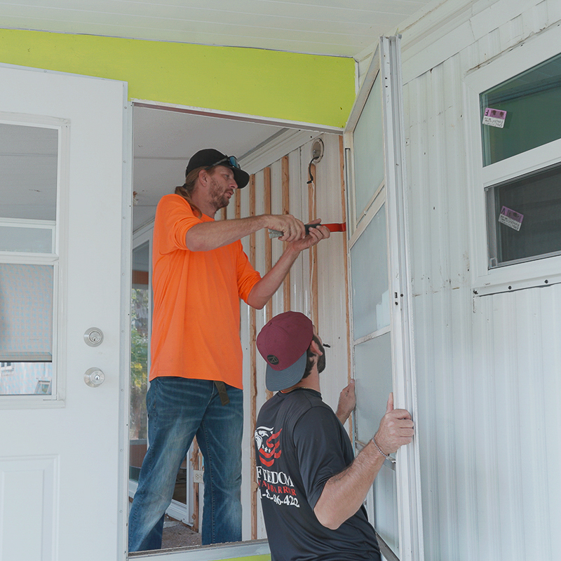 A professional from our team carefully sealing the seams of a new vapor barrier installation in a Bonita Springs mobile home.