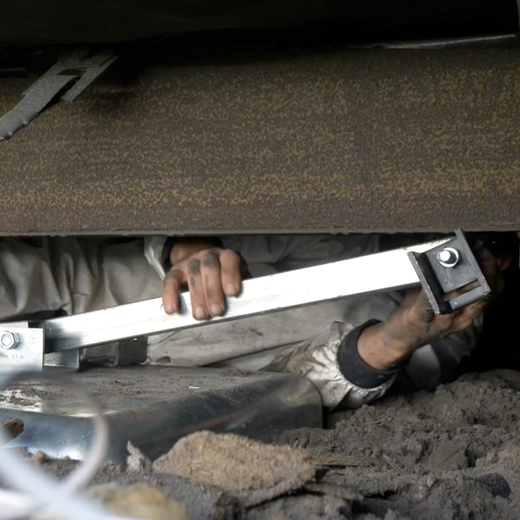 A set of newly installed, rust-resistant mobile home tie-downs securing a home in Winter Haven for hurricane season.