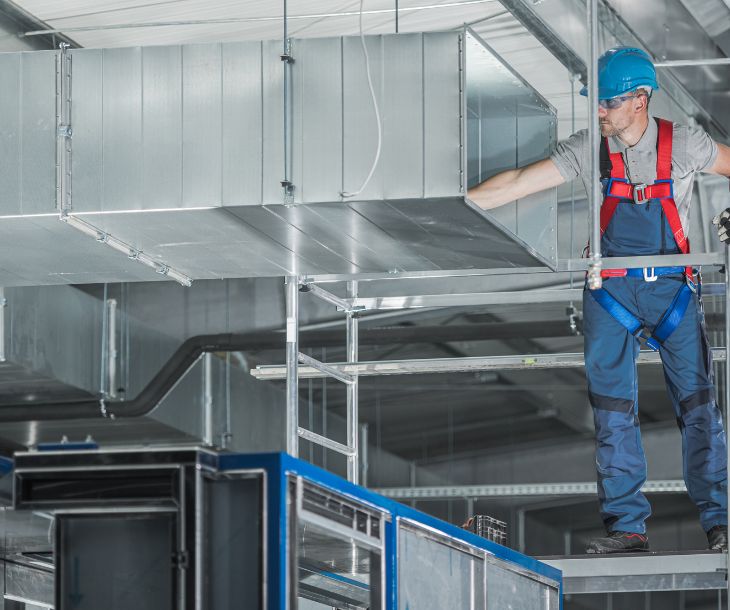 technician installing hvac ducts