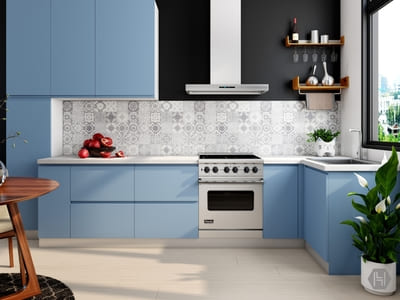 Contemporary kitchen with blue cabinets, a patterned tile backsplash, and a sleek white stove, combining modern design with vibrant color accents.