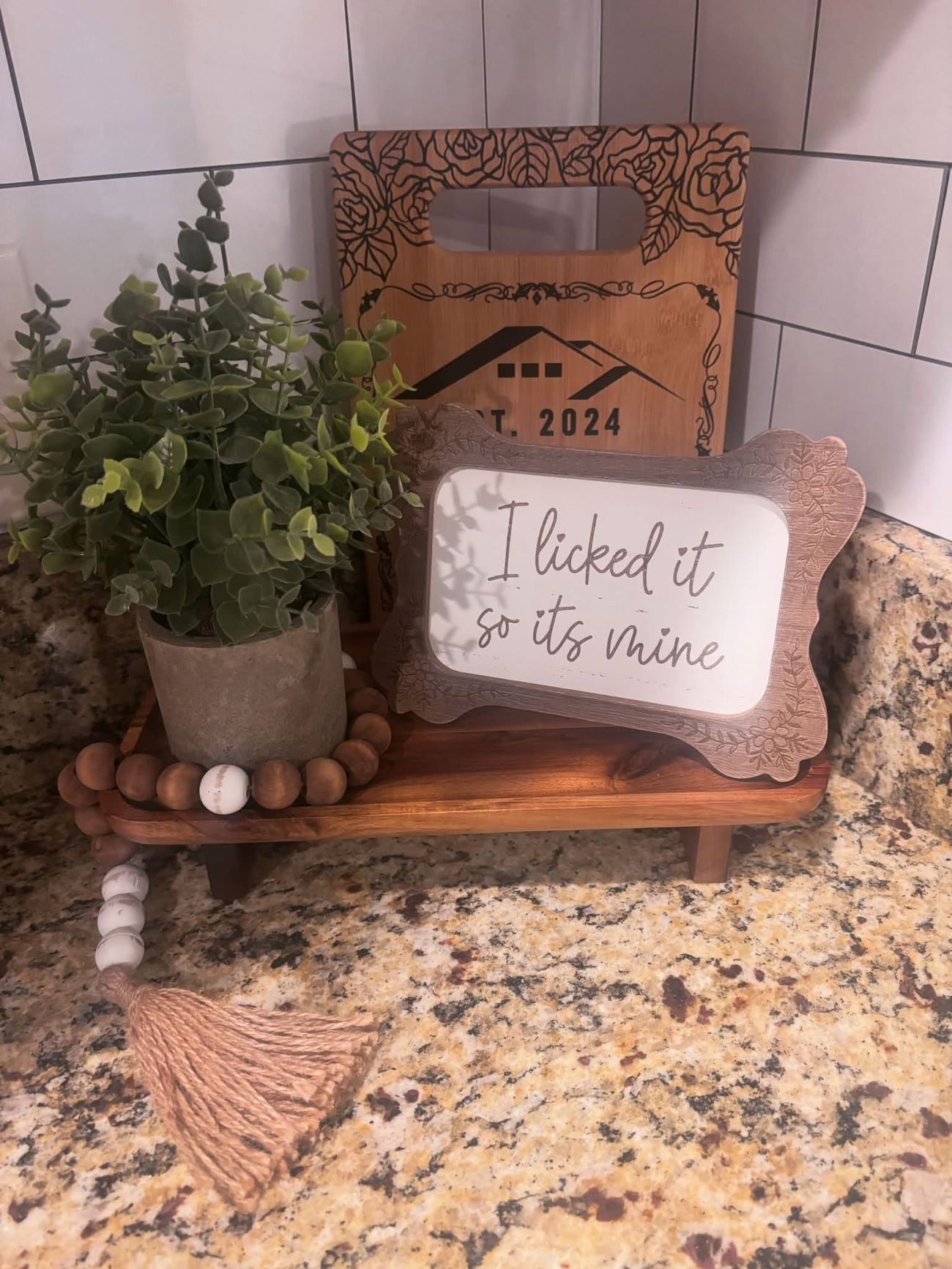 A styled counter with a plant and small decor