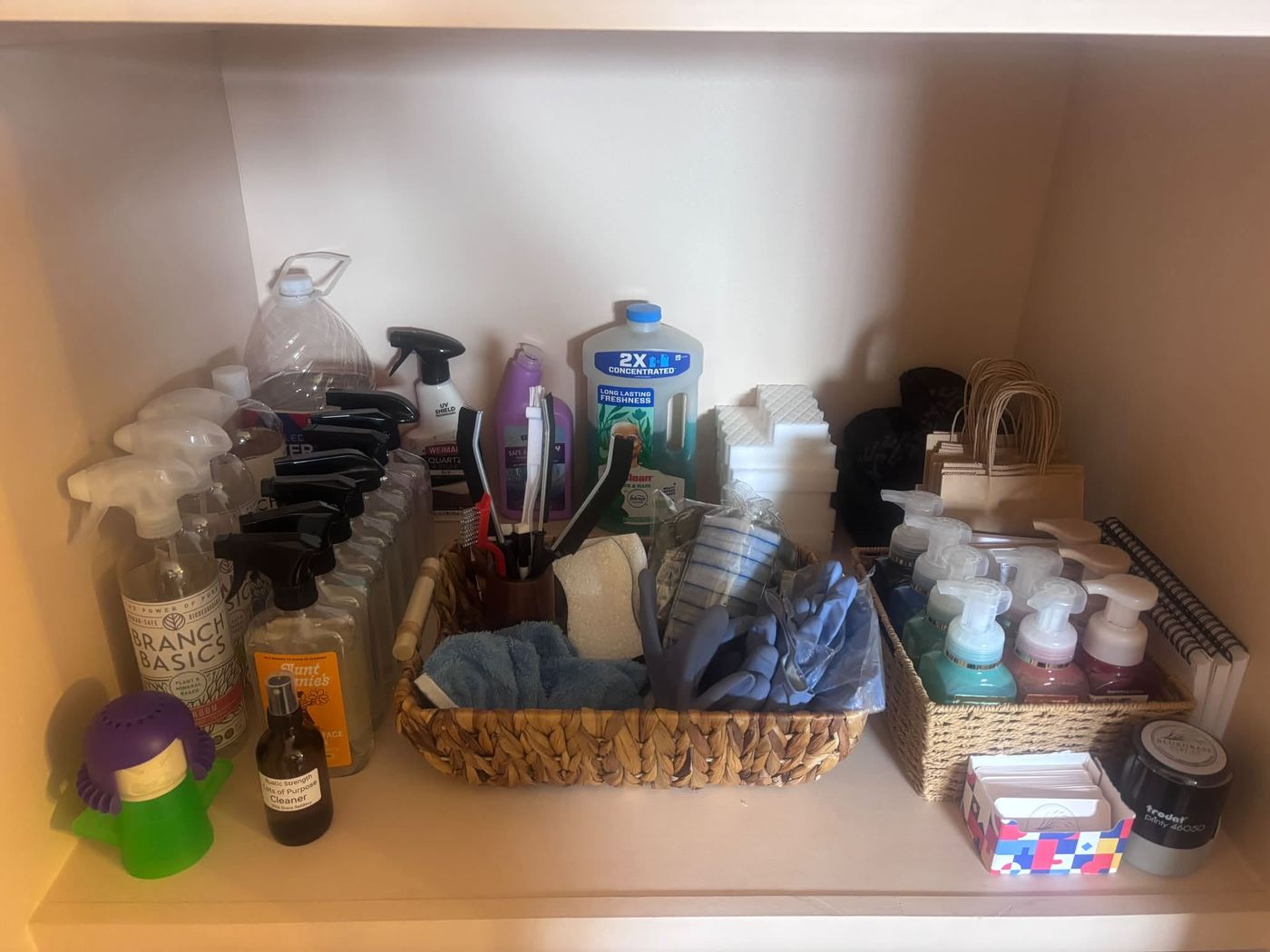 An organized cabinet with supplies in baskets