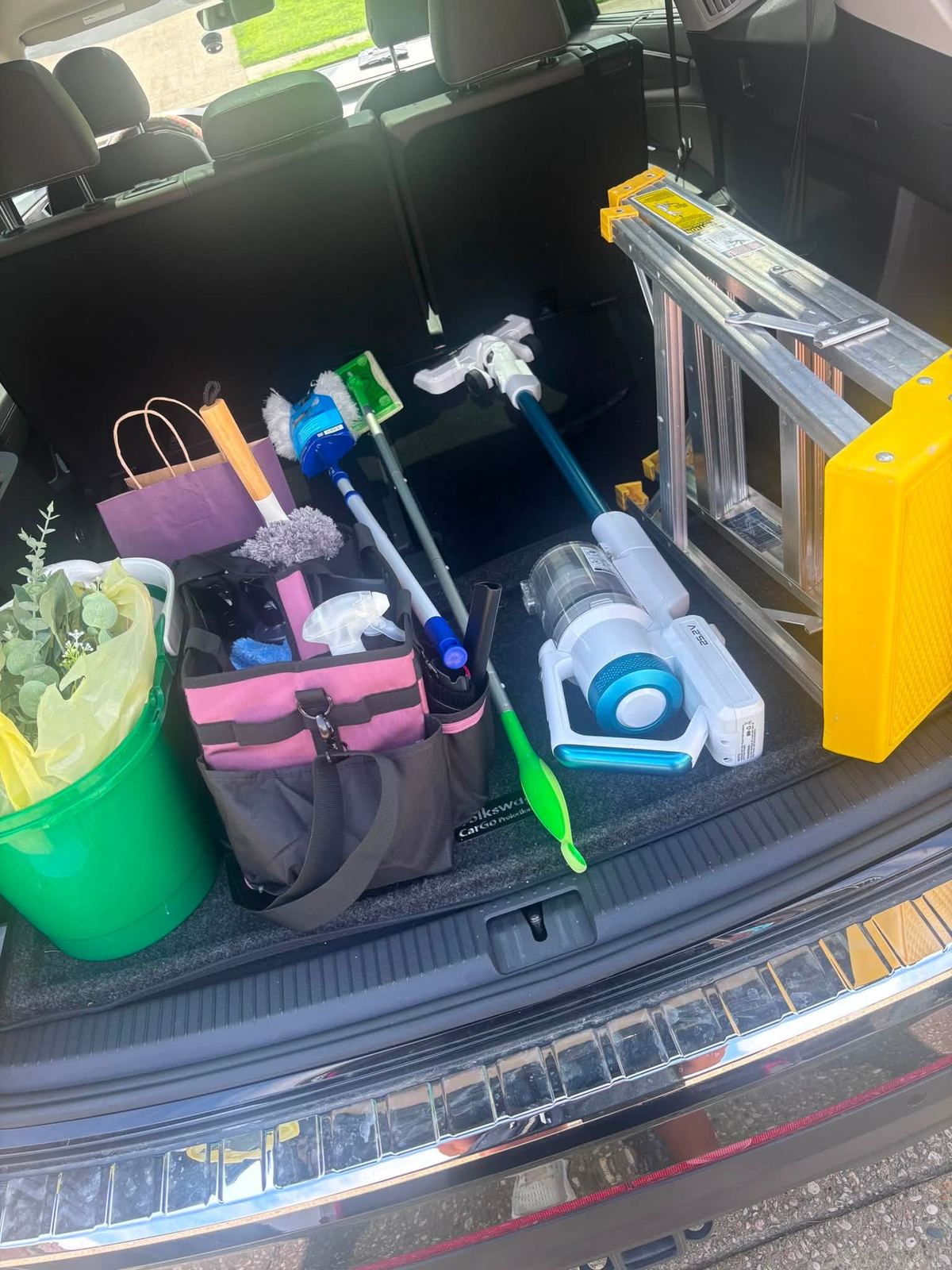 Cleaning supplies organized in the back of Lauren's vehicle