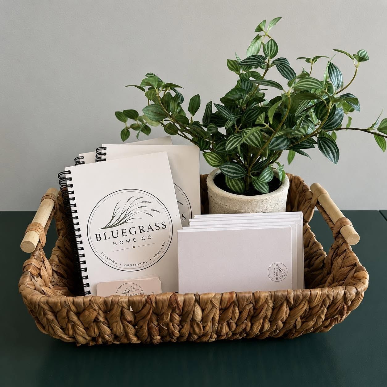 Bluegrass Home Co. branded notebooks in a woven basket