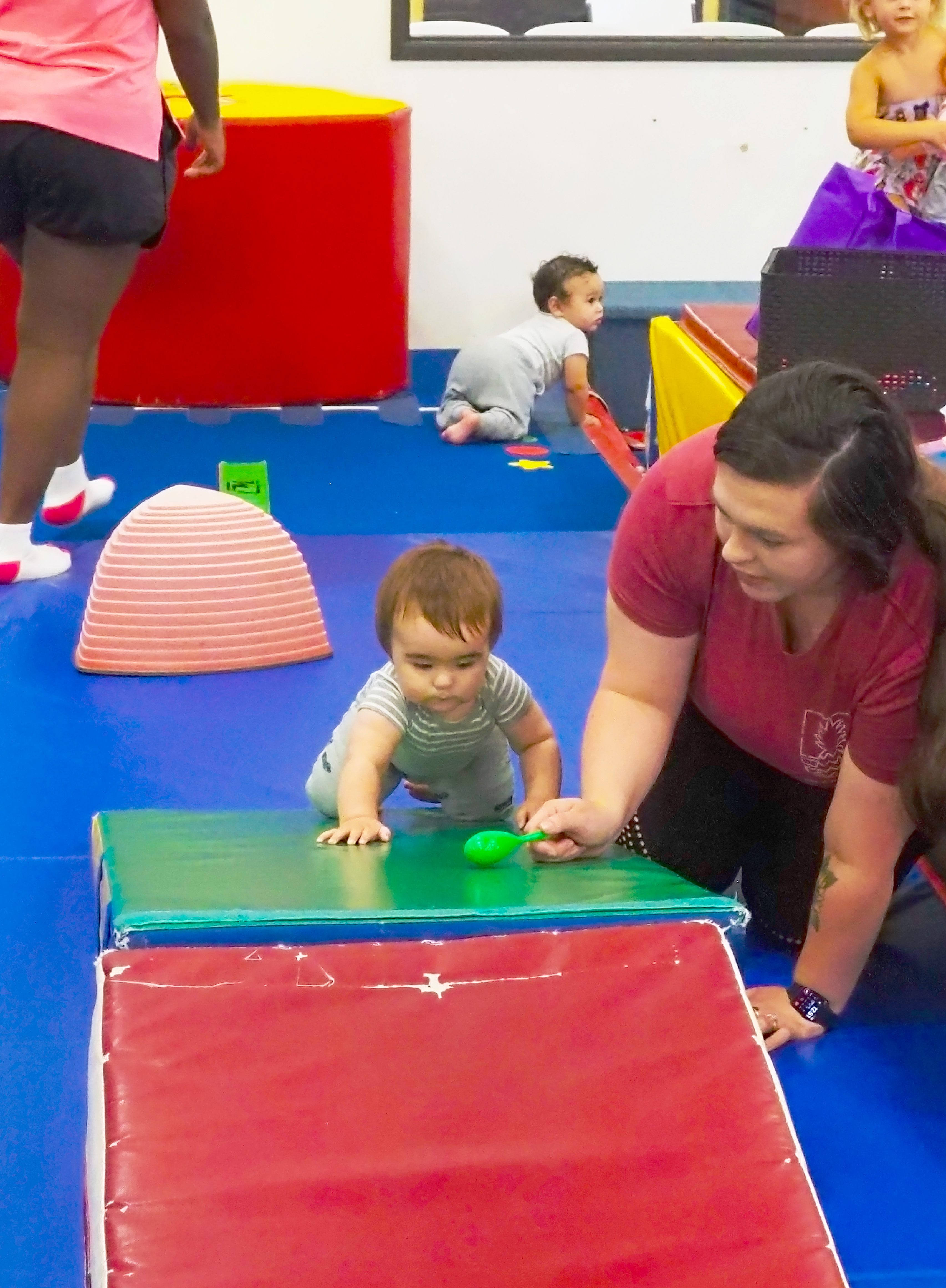 Caregiver participating with child during class