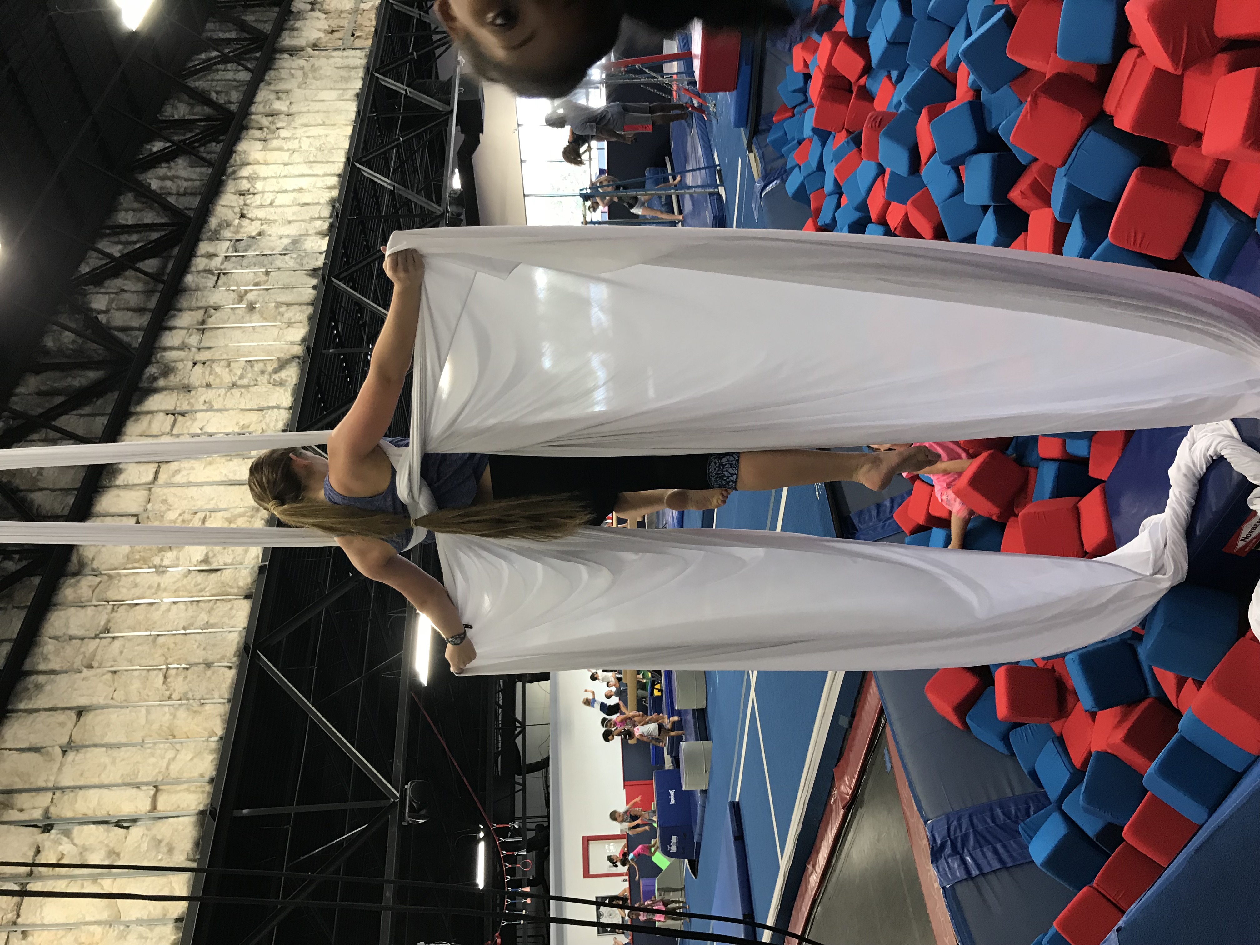 Aerial acrobatics student using fabric apparatus