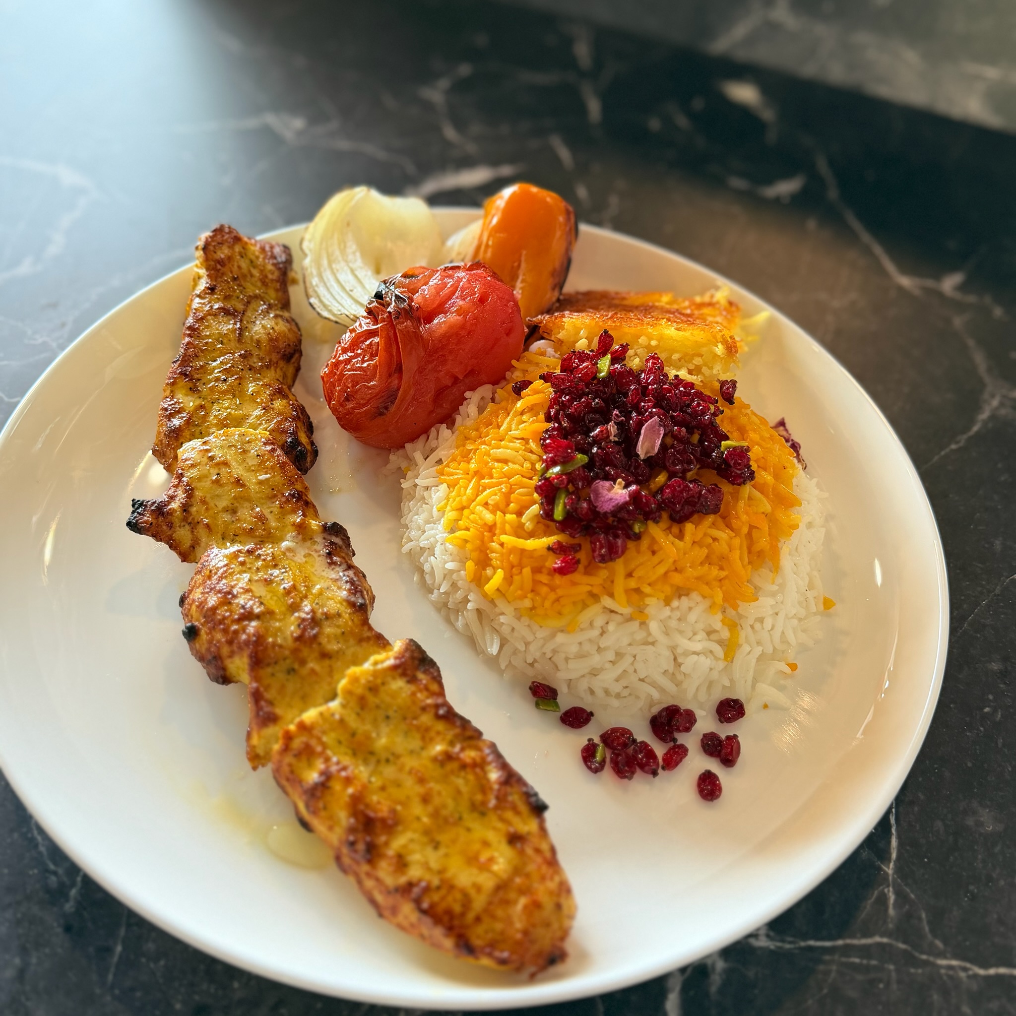 Chicken Kabob marinated in yogurt and saffron, served with barberry rice at Chop Kabob