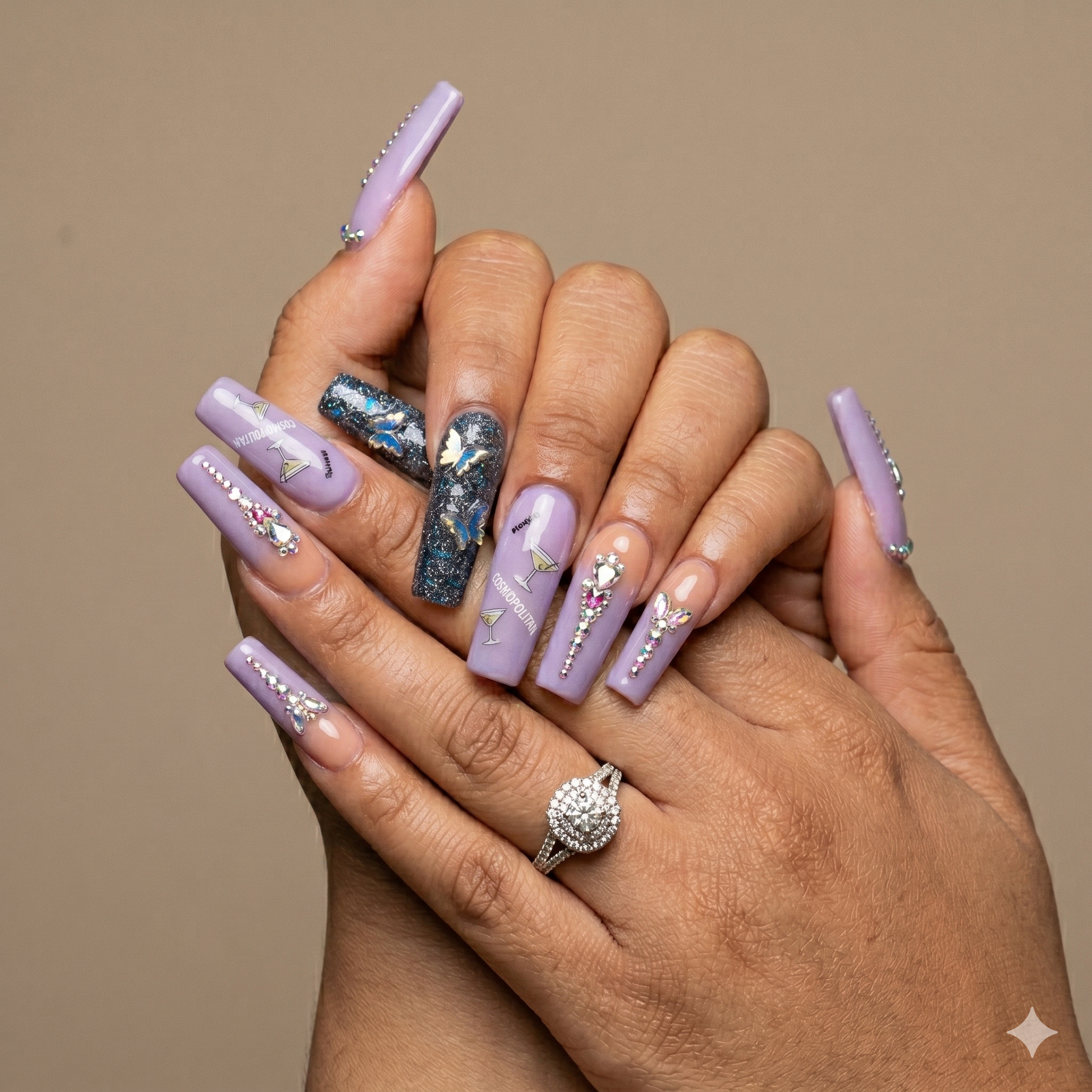 Long lavender coffin nail set with butterfly nail art, rhinestone details, and glitter accent nail — custom design at Arden Nail Studio Greenville SC