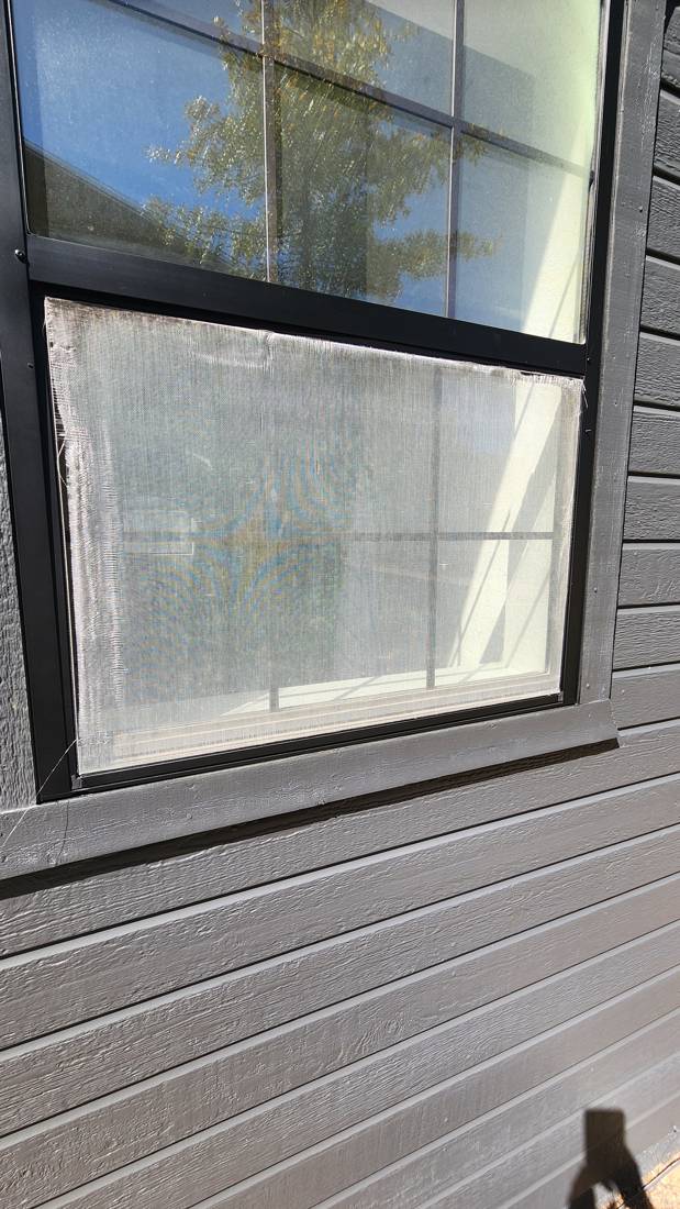 Very worn screen on a house window