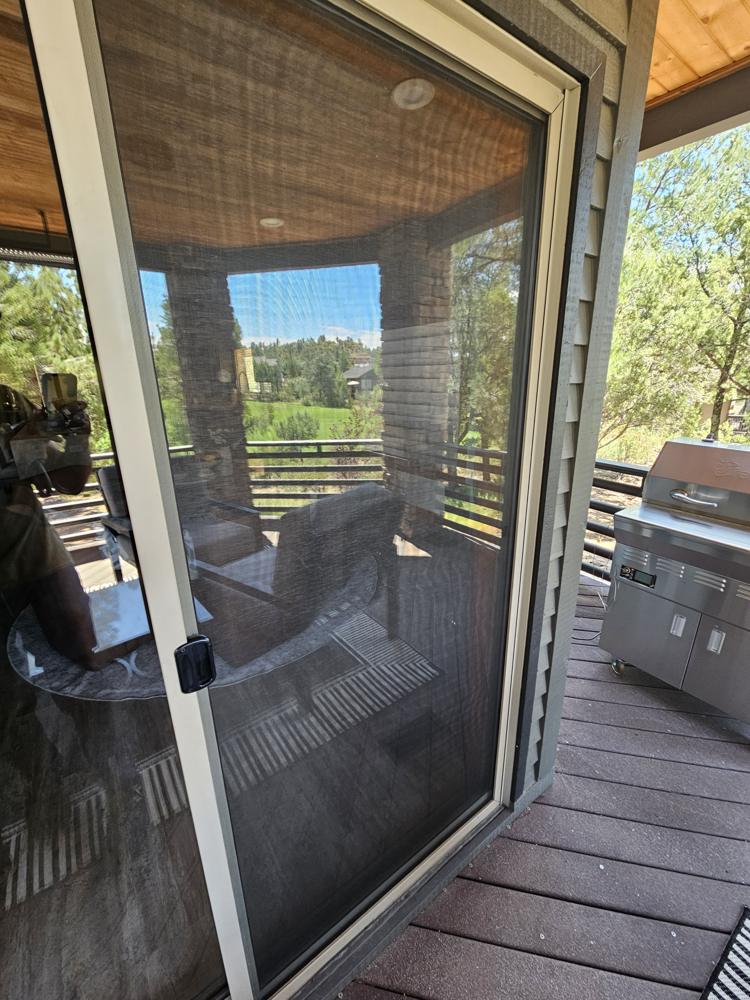 Sliding screen door on a deck after service