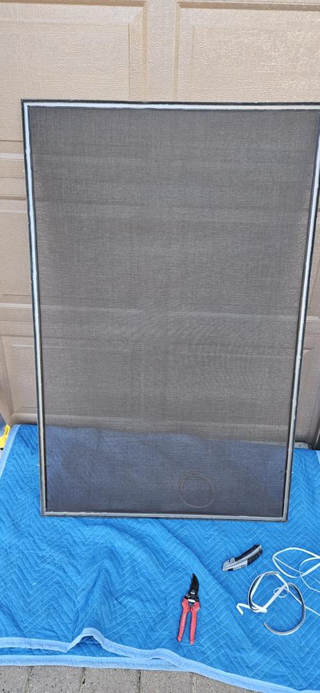Custom screen frame built and laid out on a moving blanket
