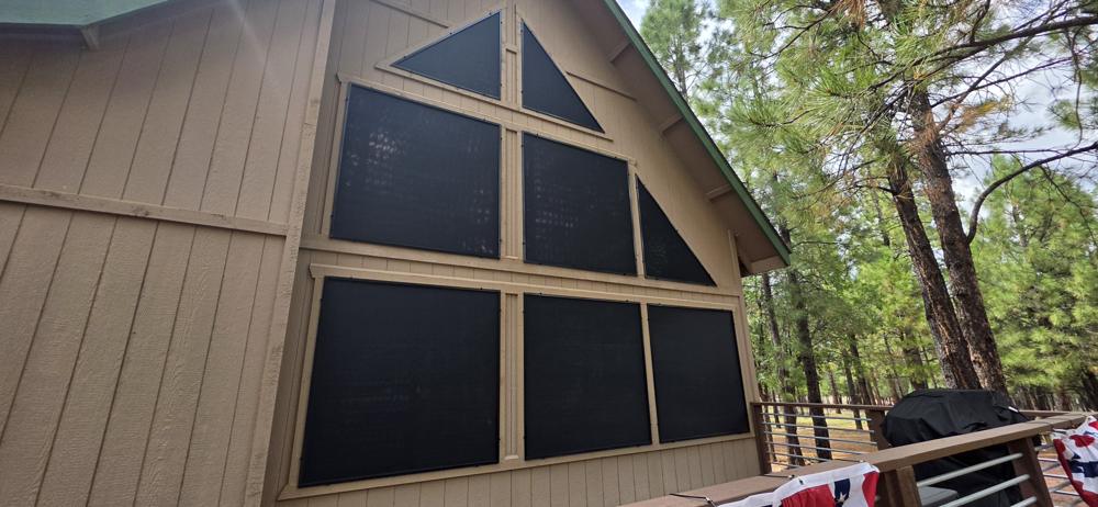 Solar screens on an A-frame home's tall windows