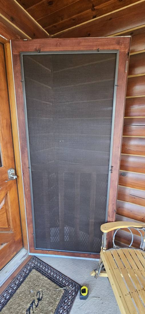 Powder-coated aluminum screen door on a log home
