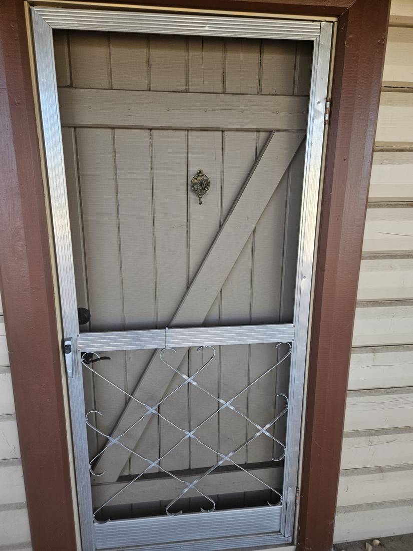 Aluminum swinging screen door with decorative grille
