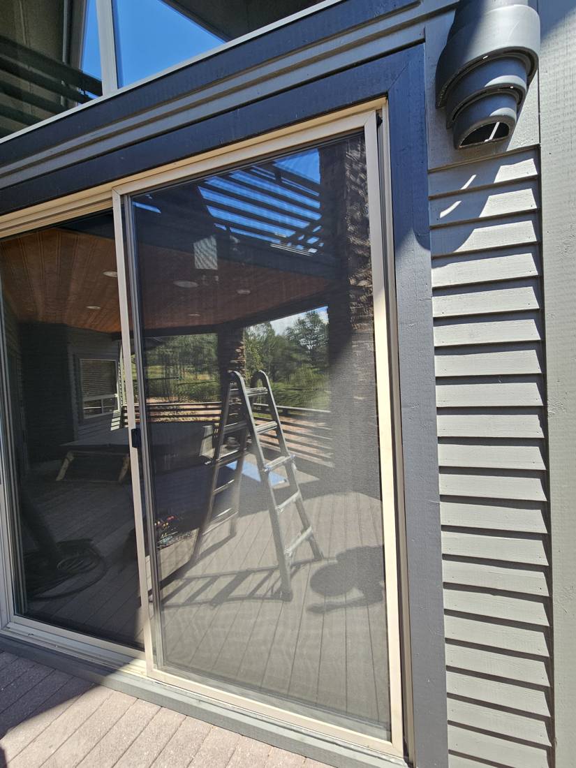 Sliding screen door on a deck after service
