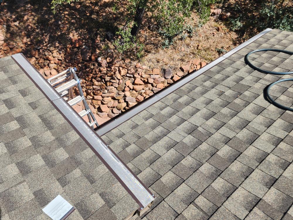 Gutter guard wrapping an inside roof corner