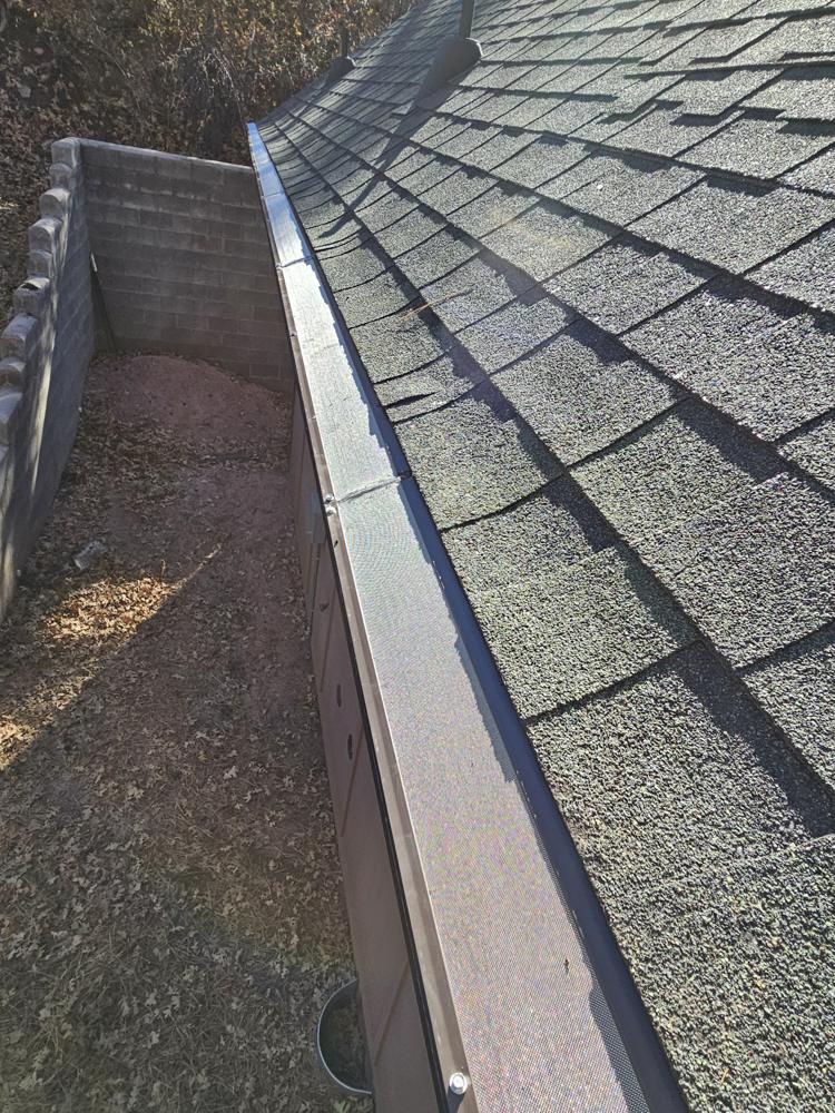 Long run of gutter guard along a roof edge