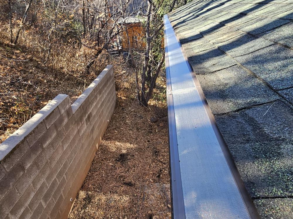 Micromesh gutter guard installed along a roof edge