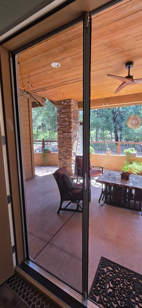 Retractable screen door opening onto a covered patio