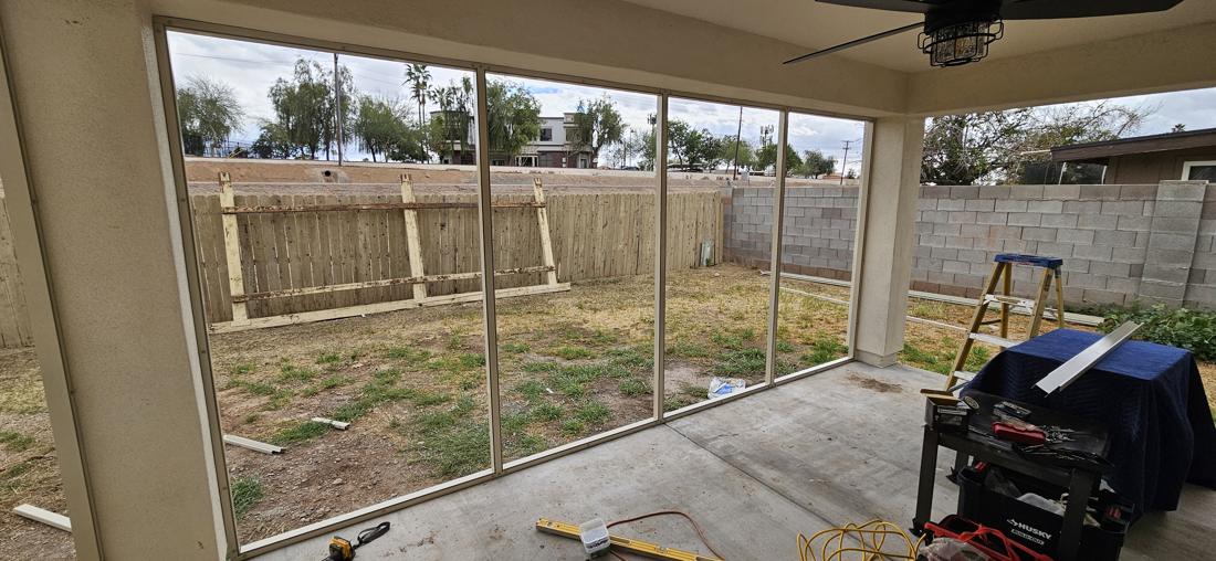 Screen room framing going up around the patio