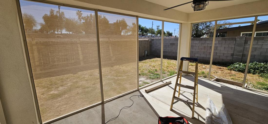 Inside a screen room with screened walls on two sides