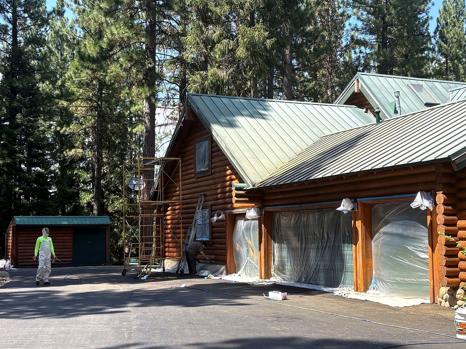 Crew masking a log home before blasting