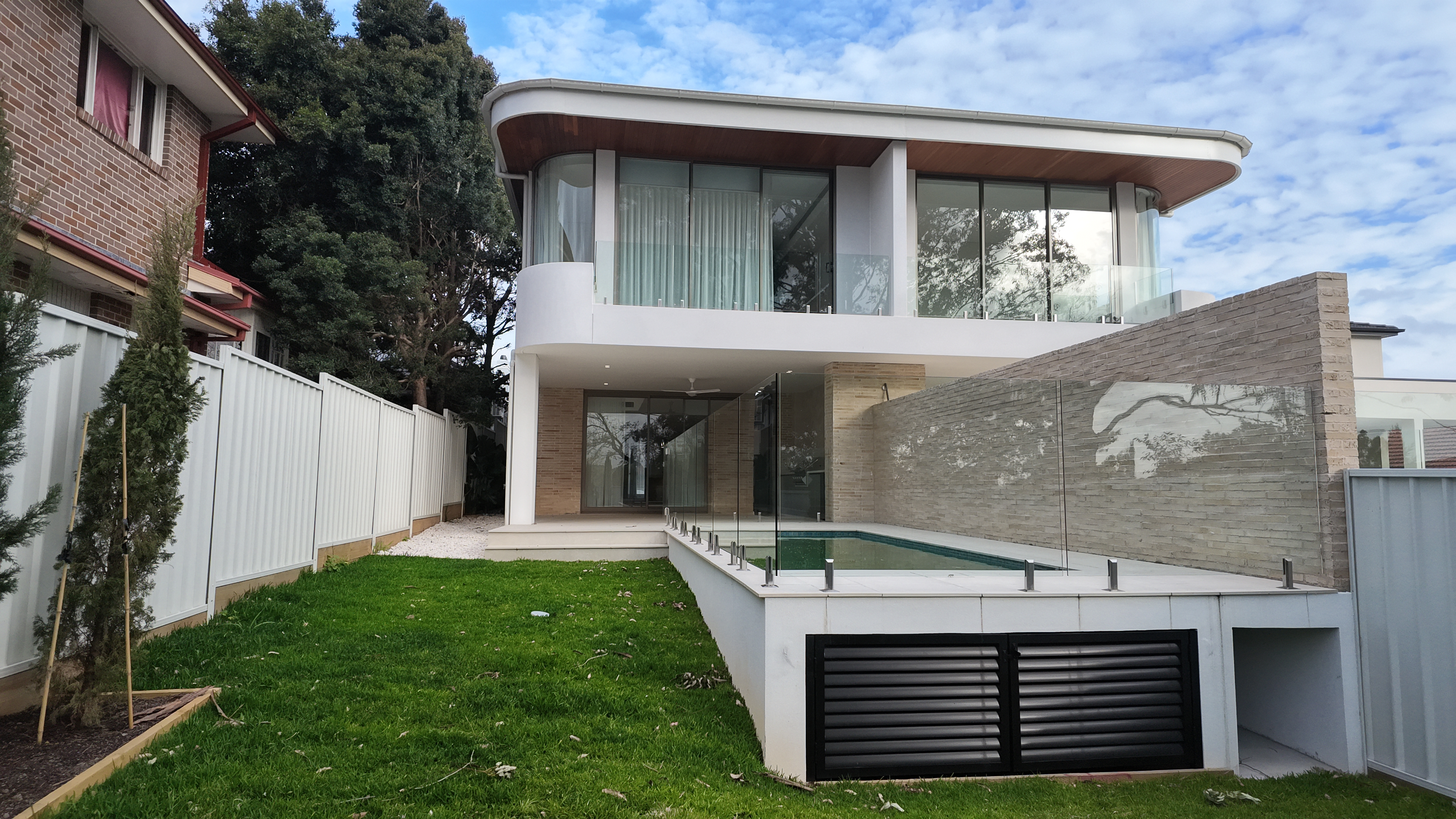 Finished home with pool and curved facade, Ross Street