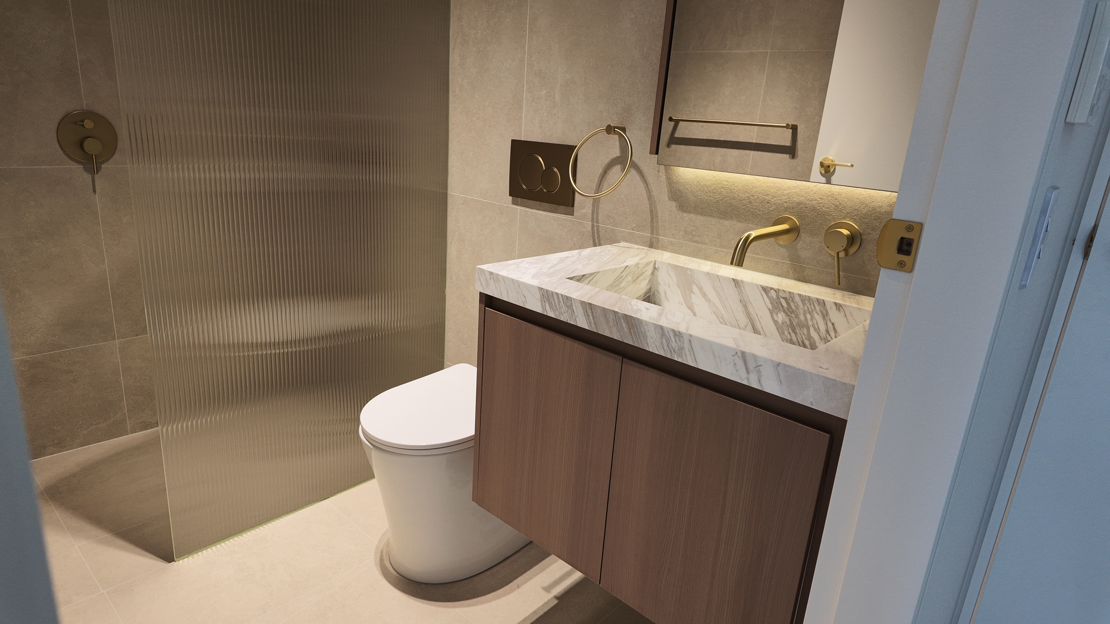 Finished bathroom detail, brass tapware and marble
