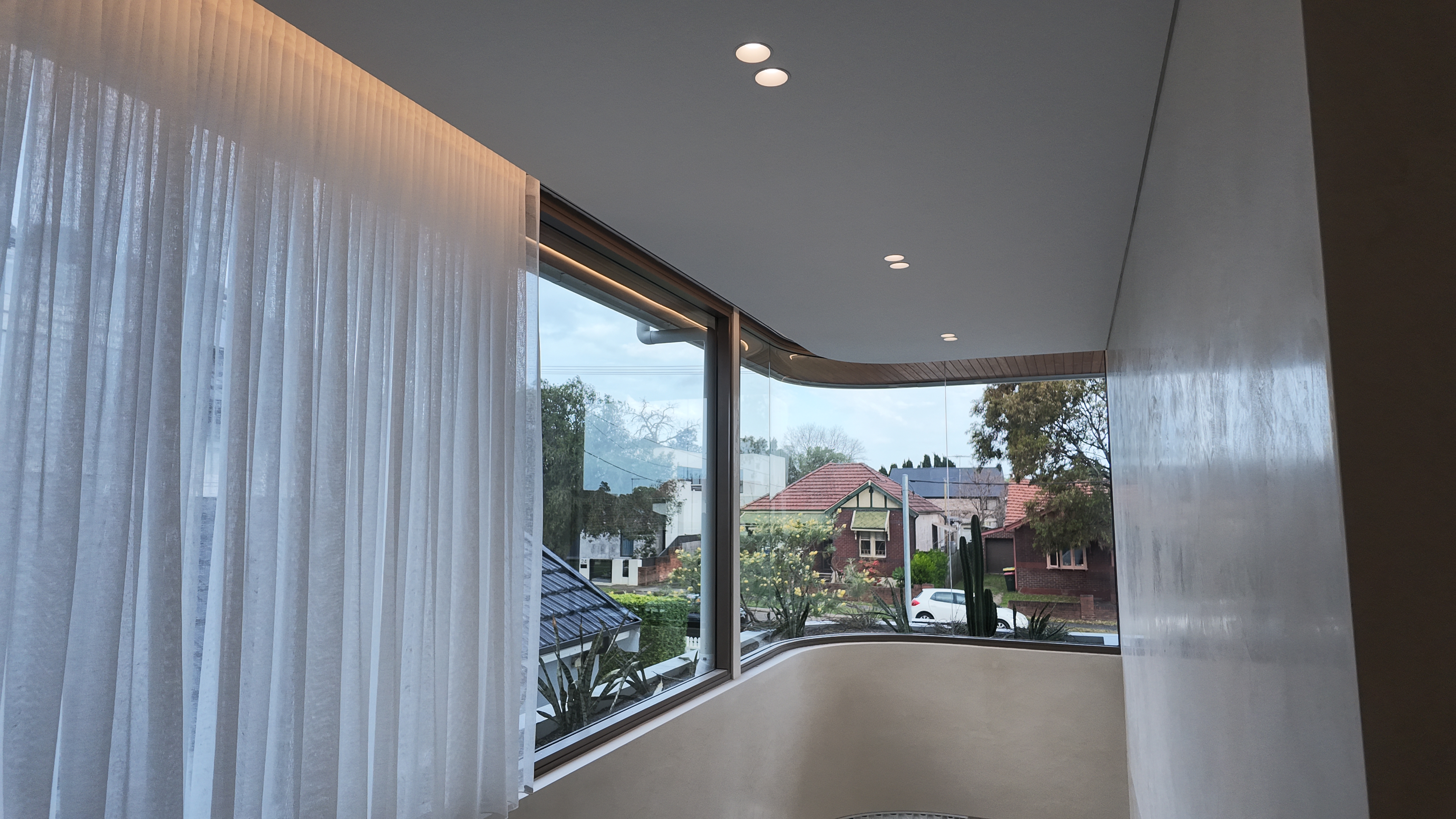 Curved glazing and living room, finished interior