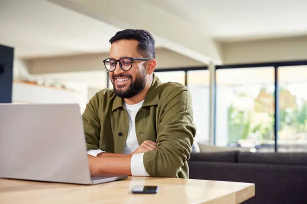 Business owner smiling at computer — powered by All Set