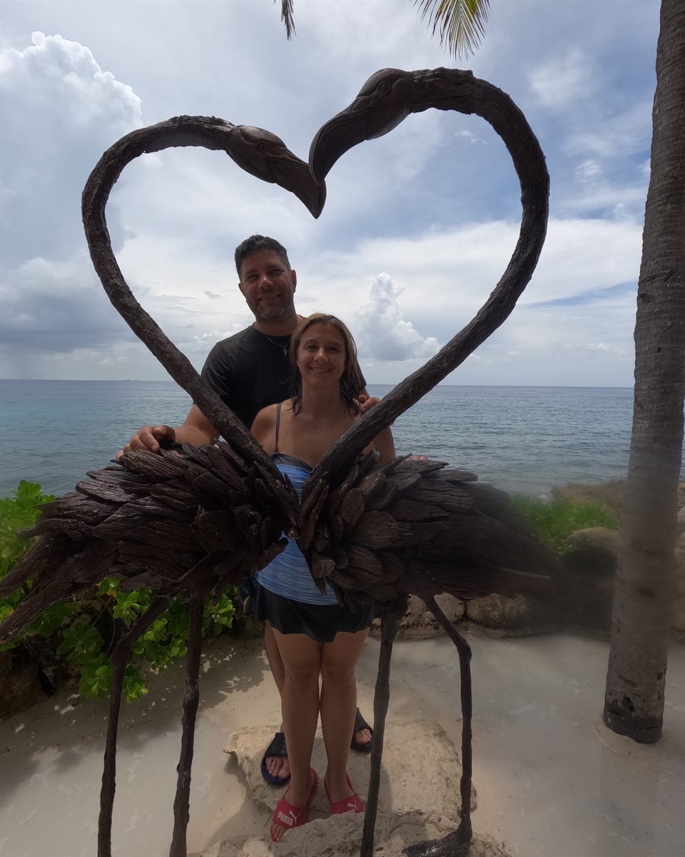 The husband-and-wife founders of Own Your Day Travel on a beach