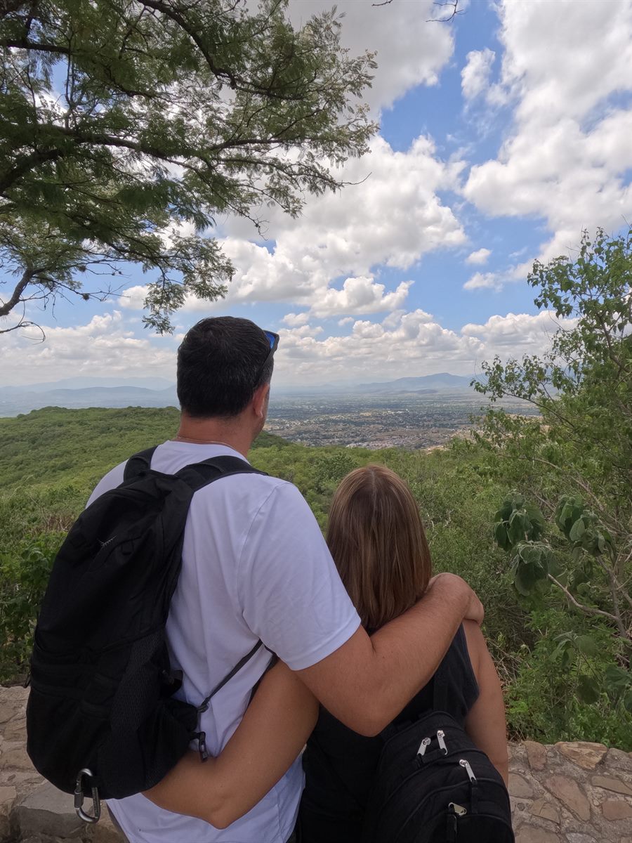 A couple looking out over a valley on a hiking trip