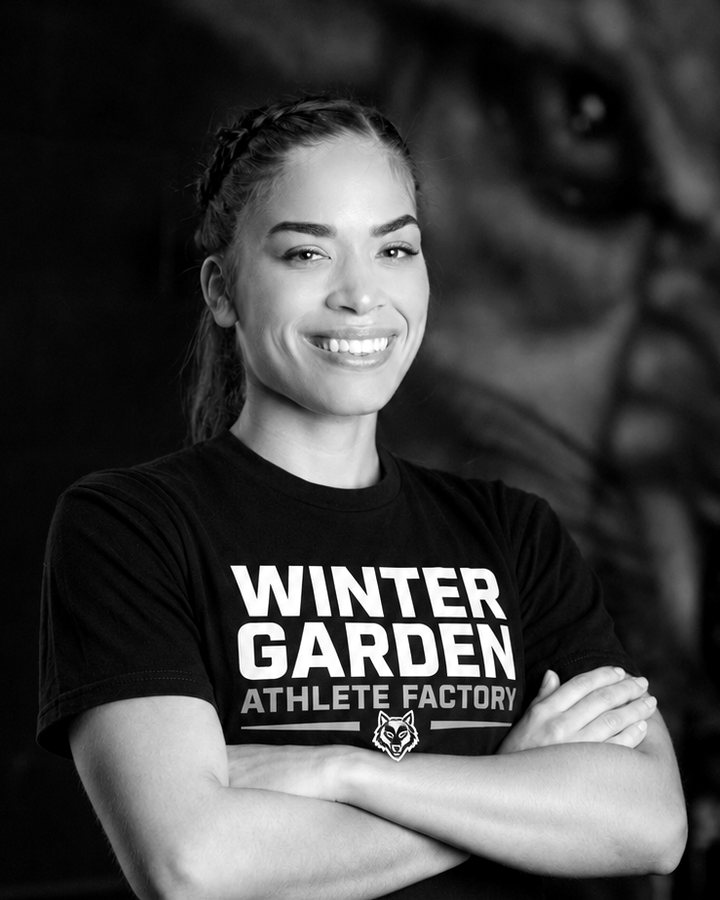 Coach Michelle smiling in a Winter Garden Athlete Factory shirt