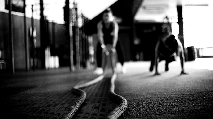 Two athletes training hard on turf