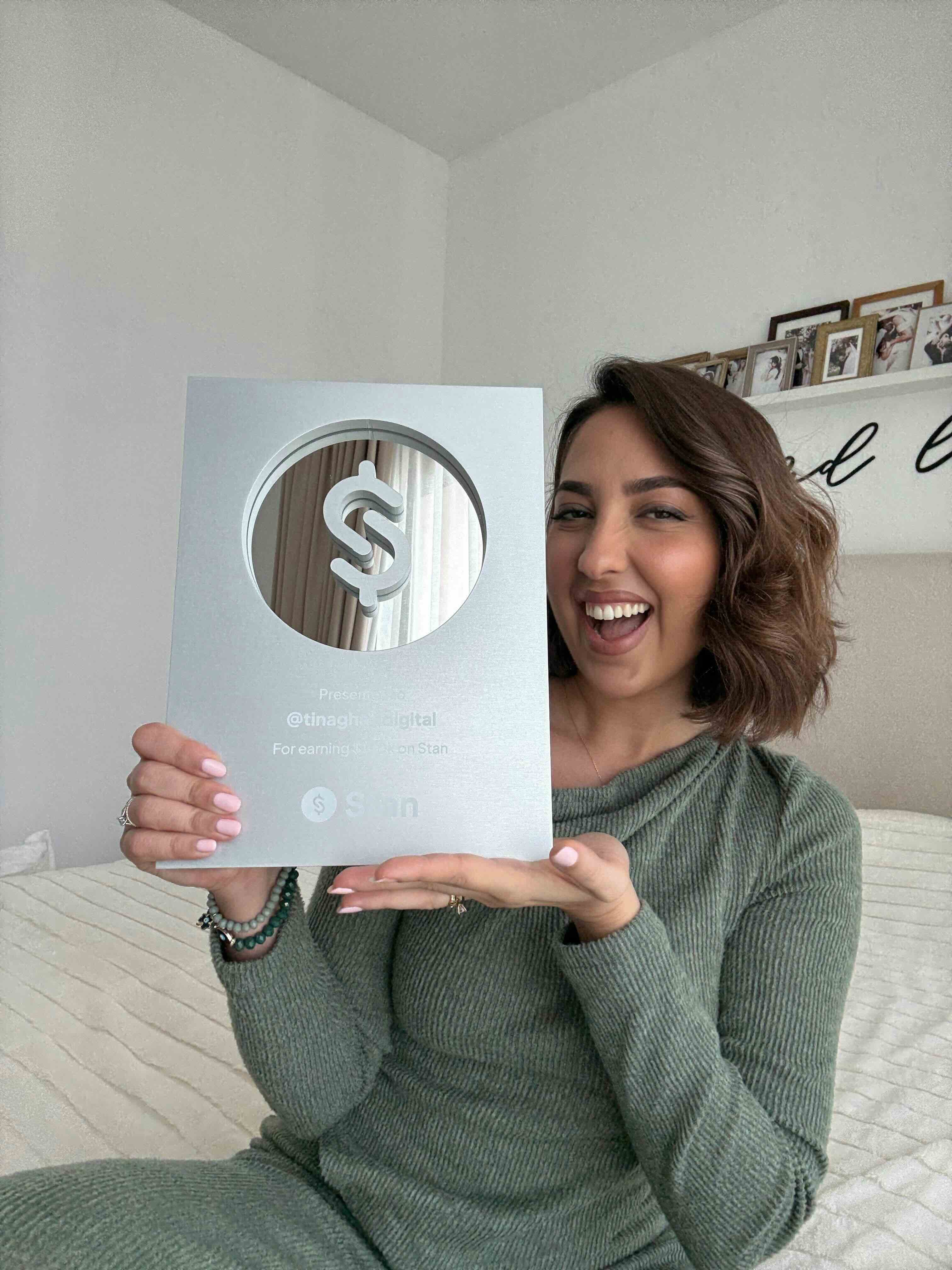 Tina holding her Stan Award