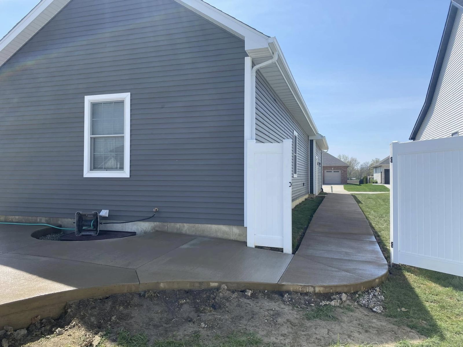 Concrete sidewalk connecting an entry and adjoining surfaces