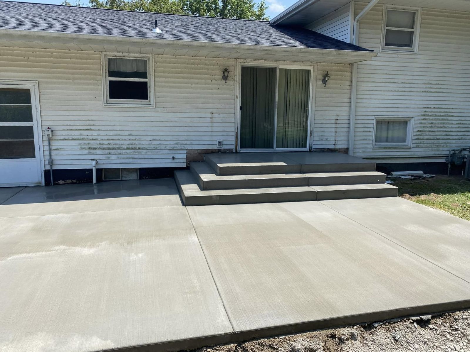 Concrete patio with seating and connection to the home