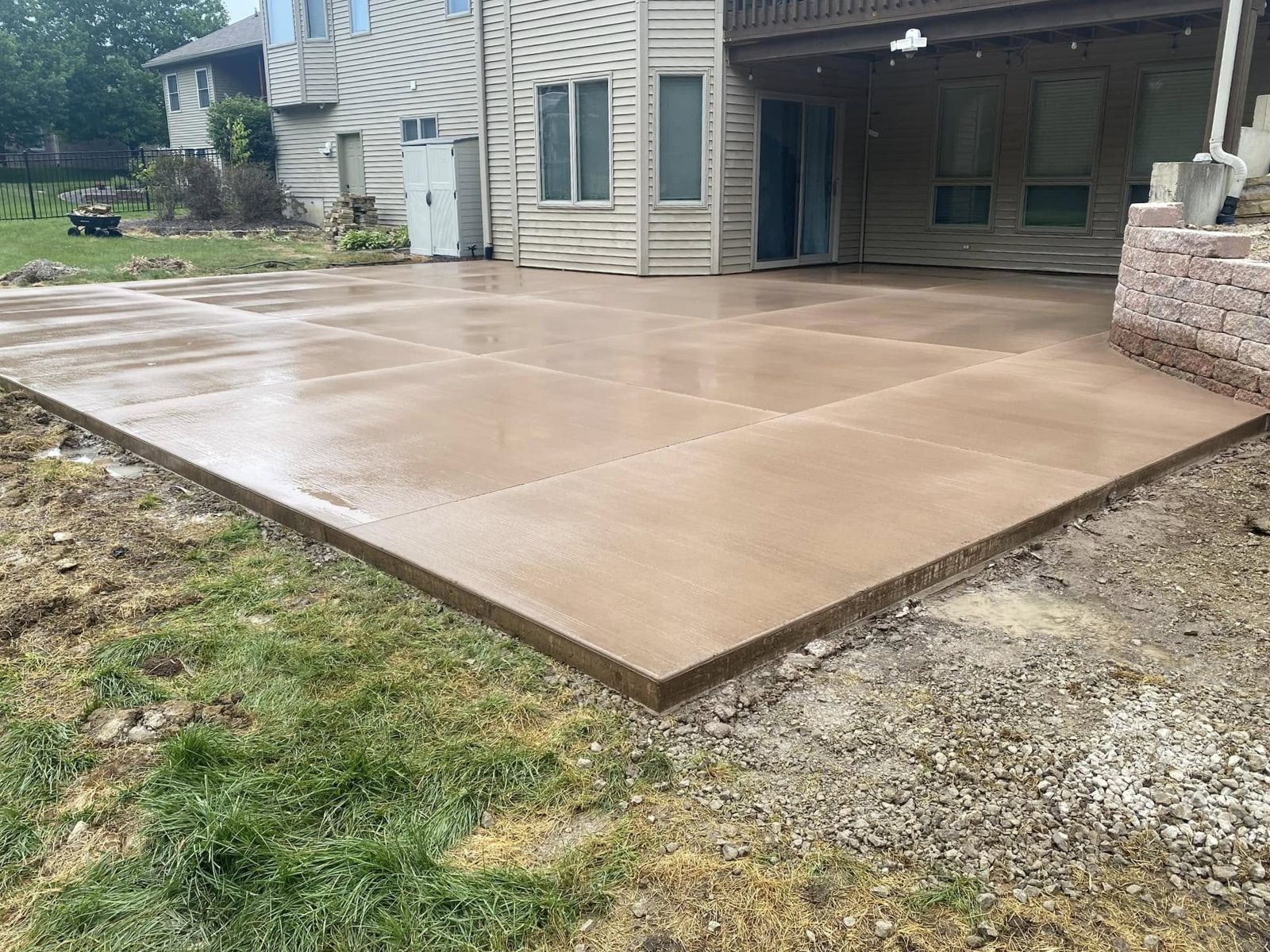 Completed concrete patio beside the house