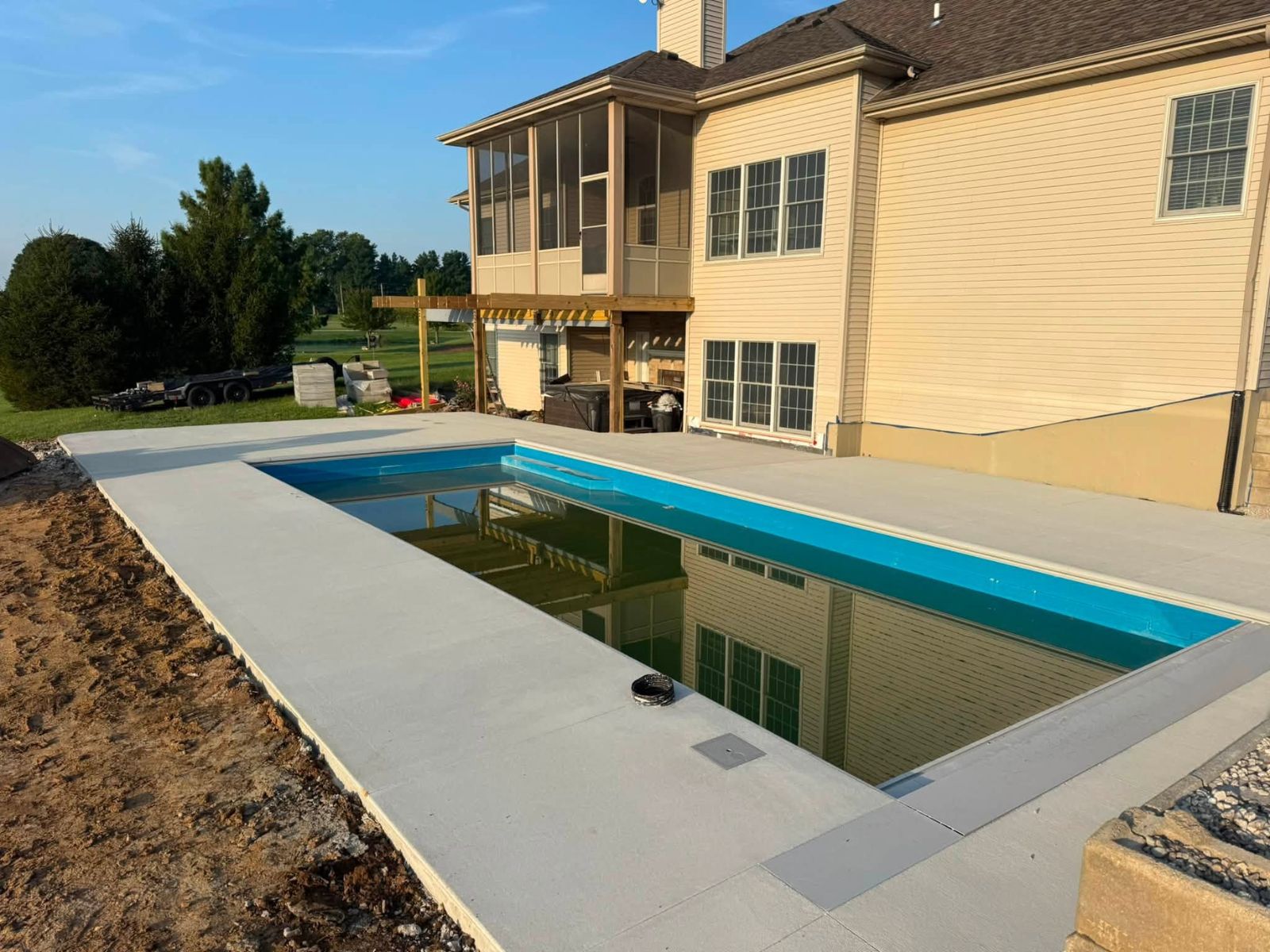 Pool deck finish and retained pool edge detail
