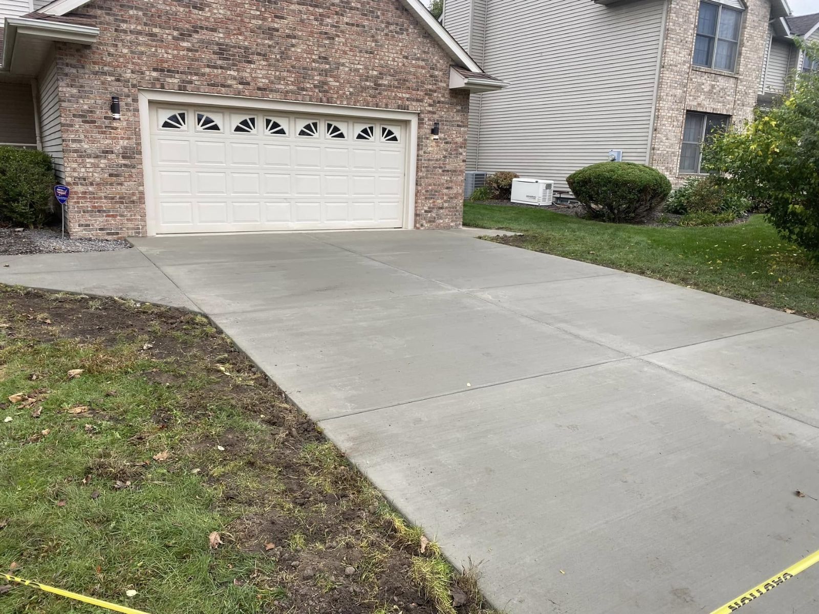 Concrete driveway showing the garage and property approach
