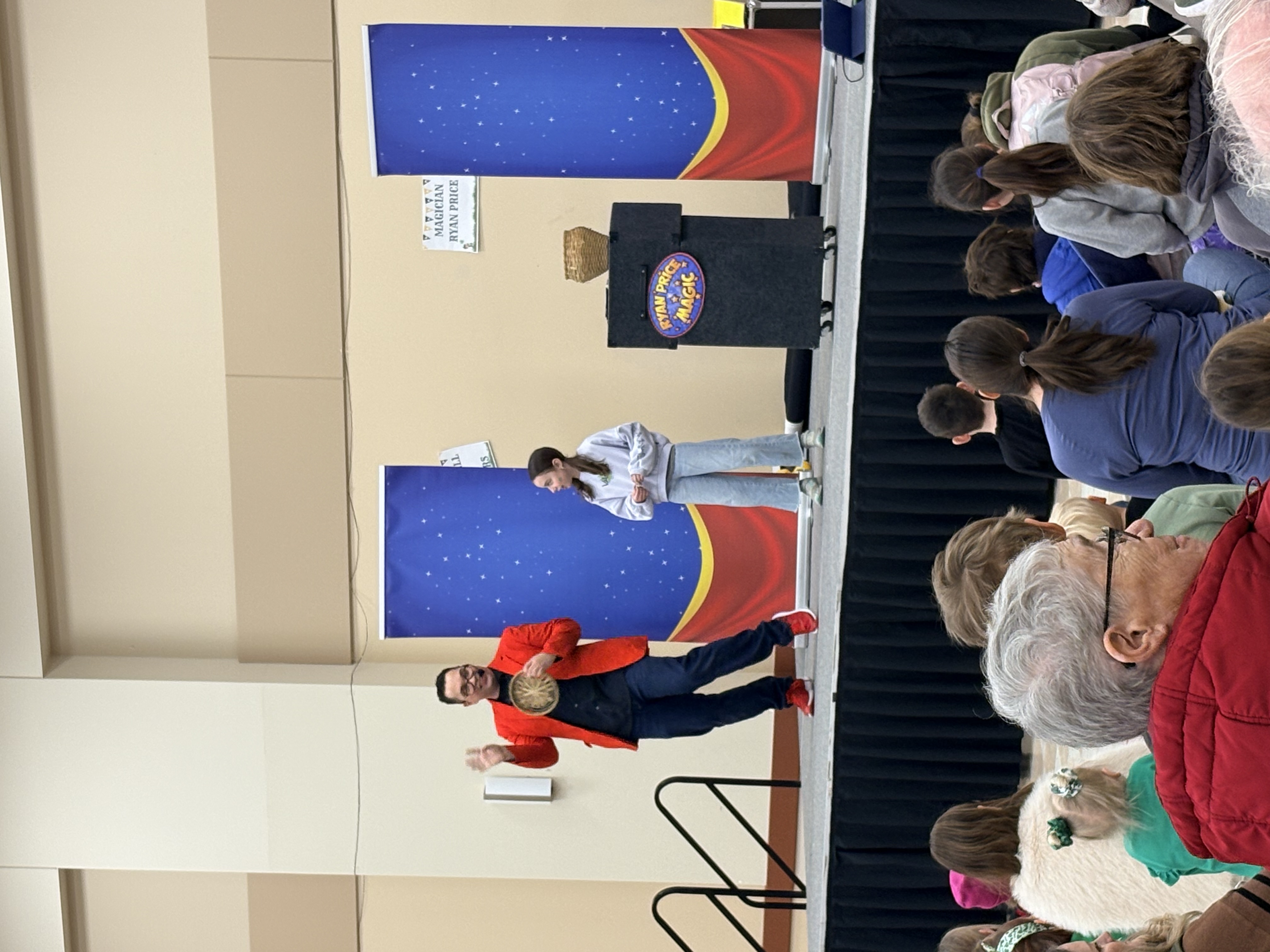 Children laughing and amazed during a Ryan Price magic show performance