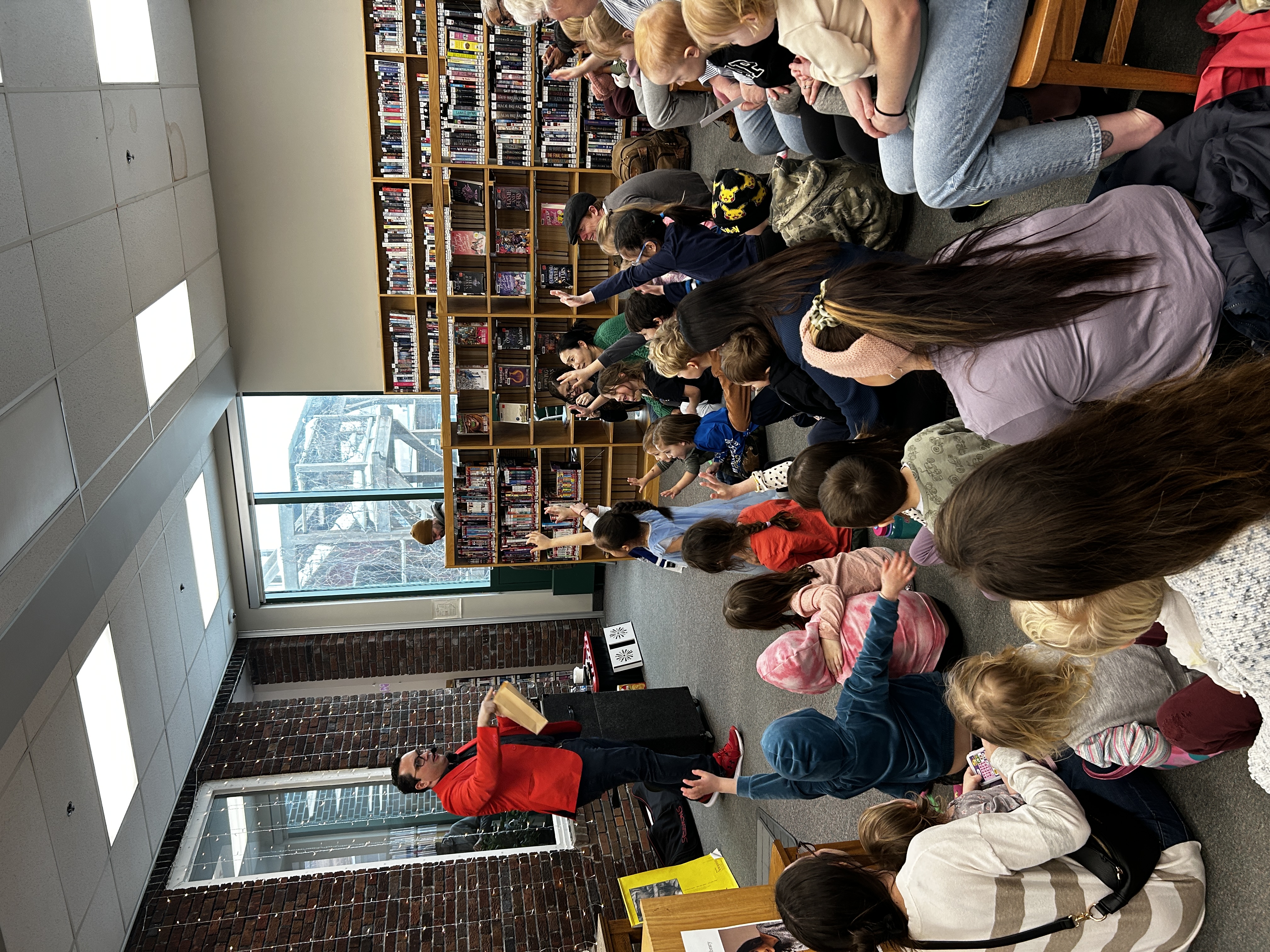 Ryan Price performing magic for families at an event in Winnipeg