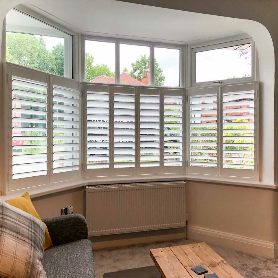 Tier-on-tier shutters fitted to a curved bay window
