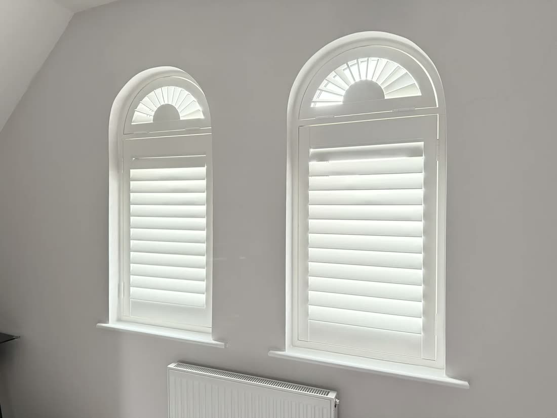 Paulownia hardwood shutters fitted to arched windows in Lymm