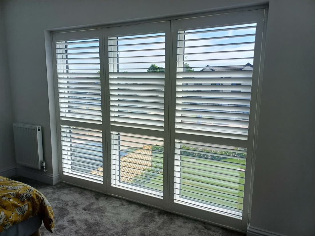 Large polyvinyl plantation shutters on a wide window