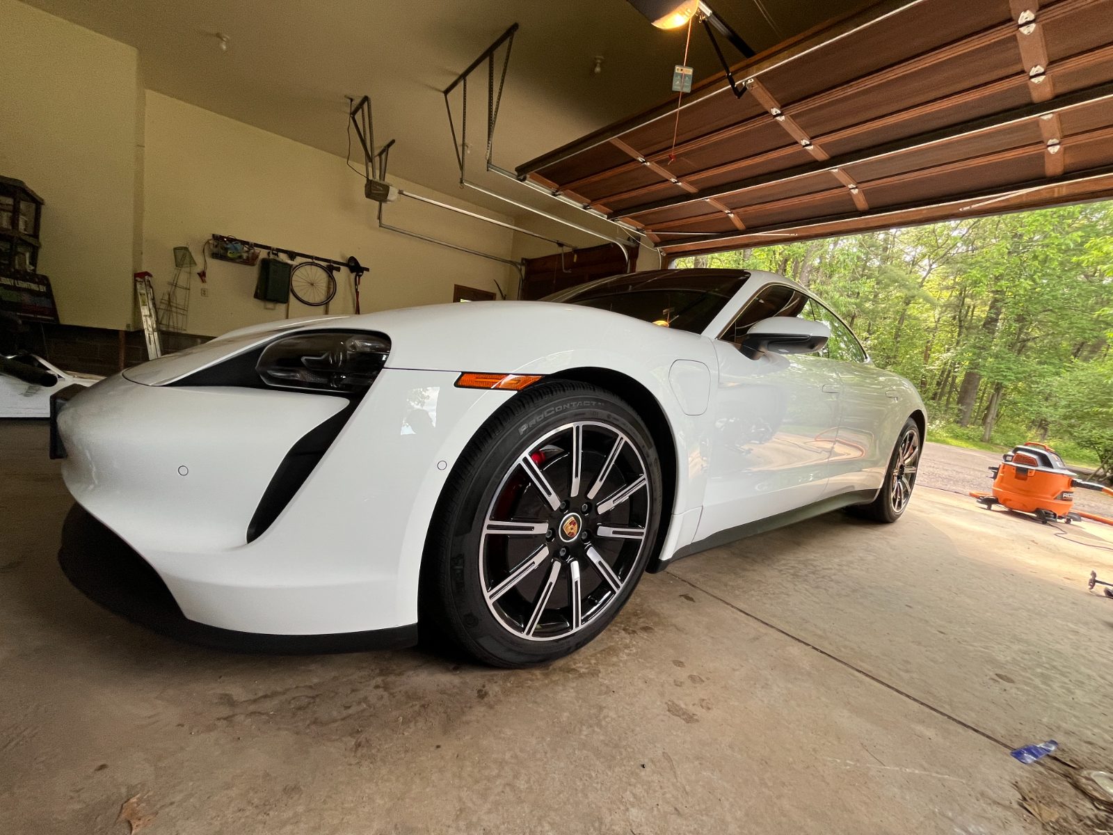 White Porsche Taycan front end gleaming after a full detail — luxury car detailing Eau Claire