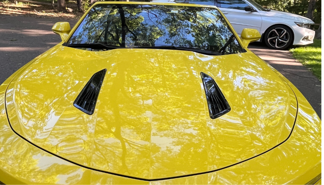 Yellow Camaro hood polished to a mirror finish after ceramic coating — ceramic coating Eau Claire