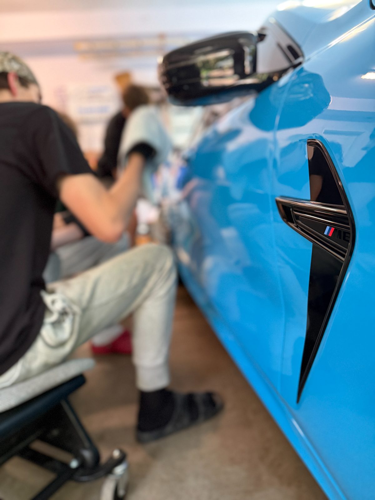 Blue BMW M8 side vent gleaming after ceramic coating — ceramic coating Eau Claire