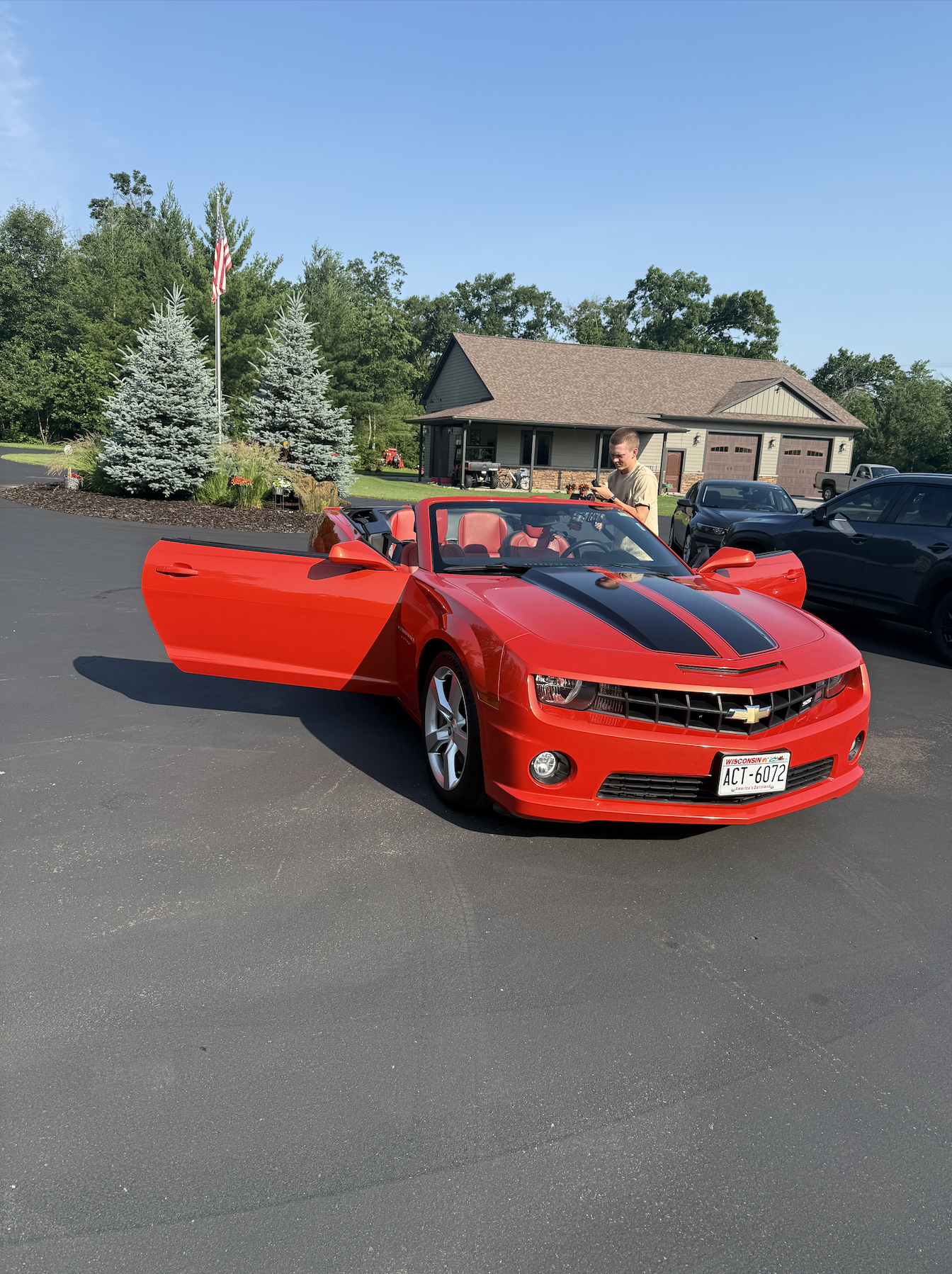 Red Camaro SS convertible freshly ceramic coated in an Eau Claire driveway