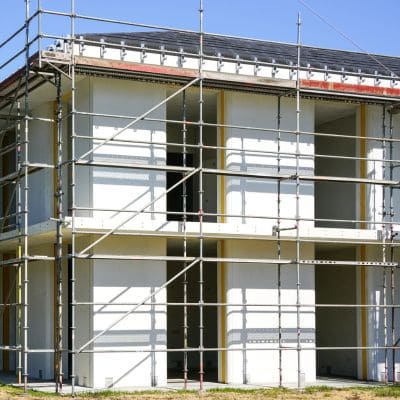 Multi-story home under renovation with scaffolding